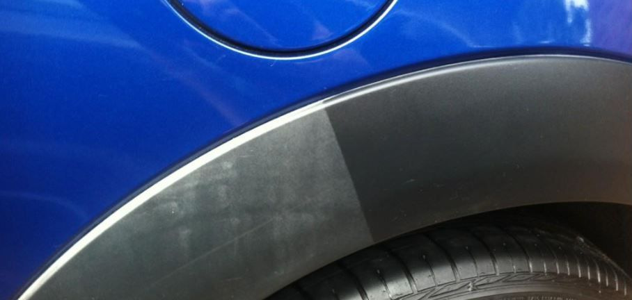 What can be used to blacken the black plastic of a car?